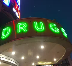 Vintage neon drug sign at the Walgreens pharmacy on Canal Street in downtown New Orleans.