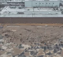 Employee parking lot is a sea of mud and storm debris at the the Baxter North Cove facility. Photo by Aerial Lens.