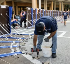 Members of the Tampa General Hospital facilities team install AquaFence panels around the lower areas of the hospital campus to protect it from expected flooding due to predicted heavy rain and storm surge water from Hurricane Helene. Photo from Tampa General Hospital.