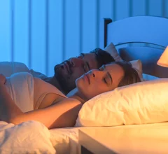 woman sleeps with lamp on