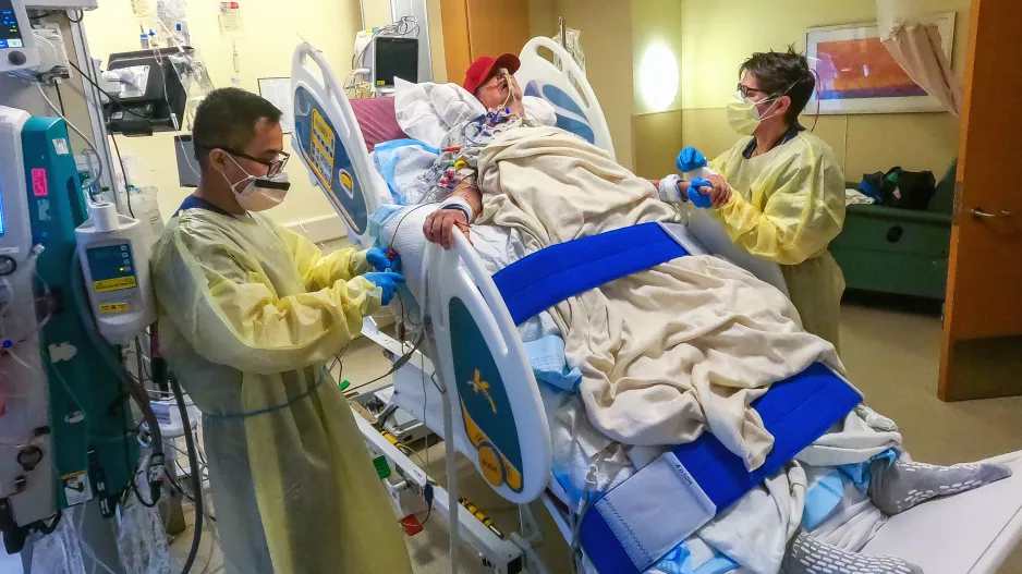 David Bennett with two of his physical therapists at the University of Maryland Medical Center