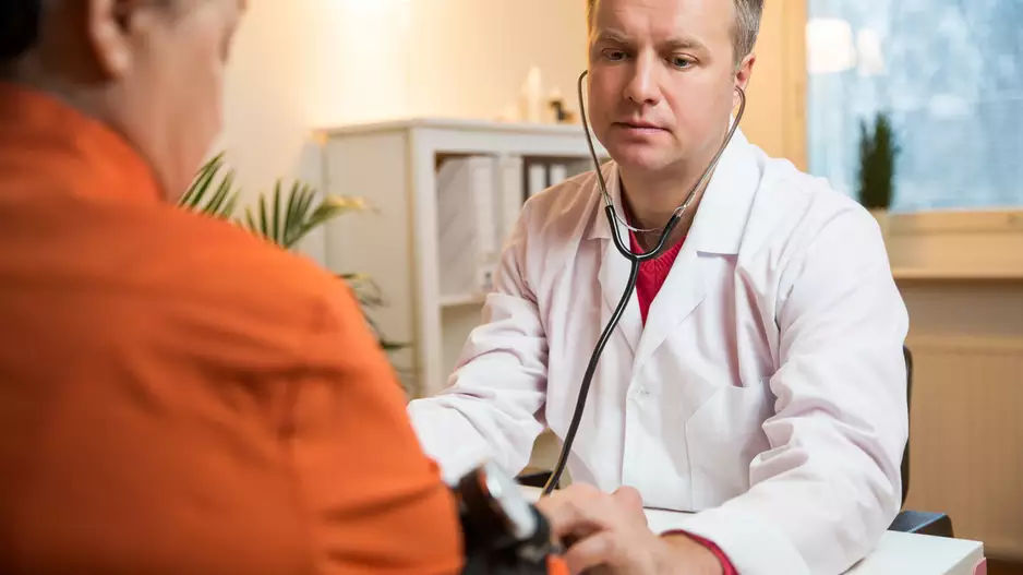 doctor with overweight patient who may be treated with TAVR or surgery