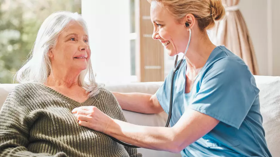 older patient with a doctor at their house