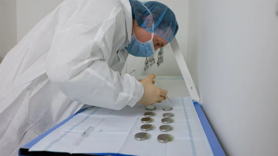Eric Puroll, a project manager with the My Heart Your Heart program, examines donated pacemakers.