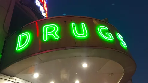 Vintage neon drug sign at the Walgreens pharmacy on Canal Street in downtown New Orleans.