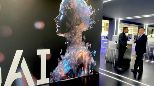 Artificial intelligence sign in the United Imaging booth. The Chinese company wants to break into the U.S. market and has a massive booth footprint at RSNA 2023. This included a section for its own AI development division. Photo by Dave Fornell #RSNA