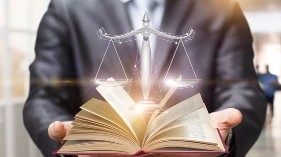 The scales of justice coming out of a book