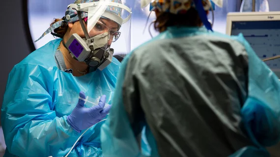 Nurses caring for a COVID-19 patient in the COVID unit at Banner University Medical Center in Phoenix.
