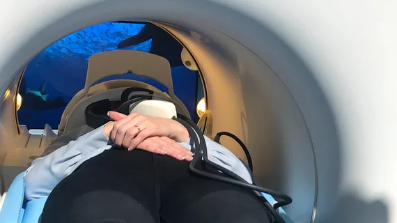 RSNA attendee tries out the new Philips 5300 MRI system video viewing system (projected on the wall behind the MRI and viewed using a mirror) to entertain patients during longer exams. The system is a "helium free" system. It has a sealed cooling system so it only uses 7 liters of helium, as opposed to the usual 1,500 liters in conventional MRI systems.