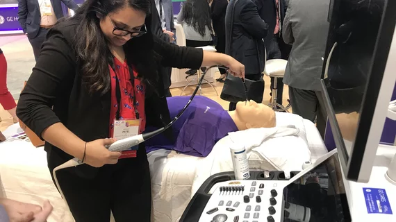 An attendee tries out a hands-on TEE simulator in a packed GE Healthcare booth at ACC.23. Photo by Dave Fornell